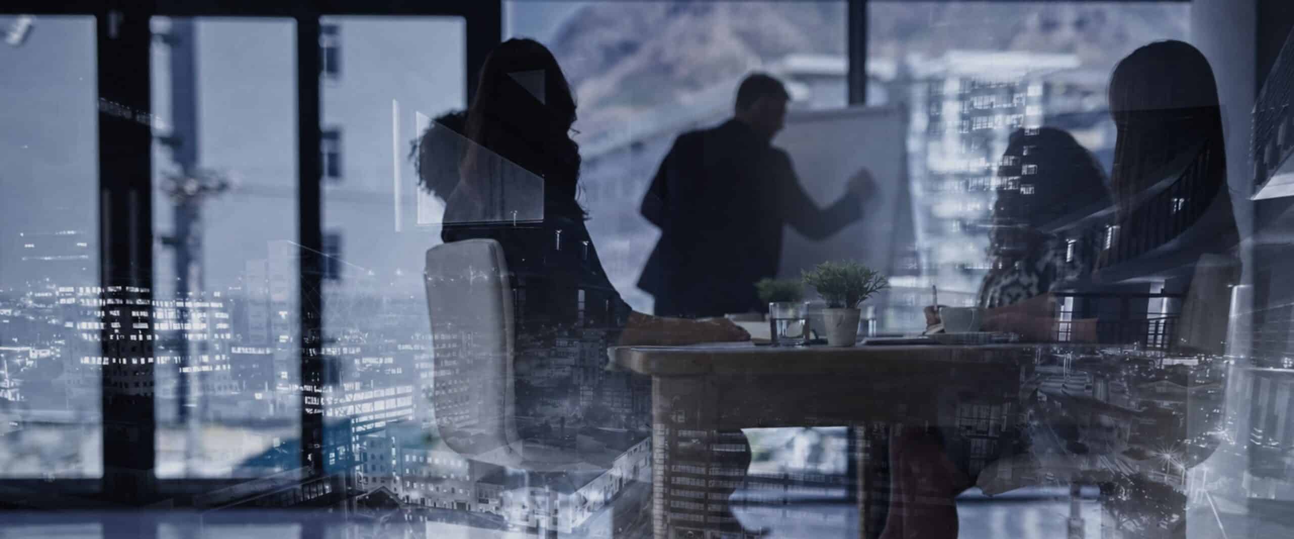 Silhouetted professionals in a glass-walled conference room, with a city skyline and digital data reflections on the glass.
